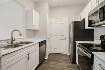 Kitchen with black appliances at The Enclave at Crossroads, Raleigh, 27606